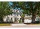Charming two-story home featuring blue shutters, dormer windows, and a two-car garage, surrounded by lush greenery at 3508 Henrietta Hartford Rd, Mount Pleasant, SC 29466