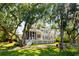 Backyard of home features lush landscaping and screened porch at 3508 Henrietta Hartford Rd, Mount Pleasant, SC 29466