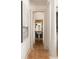 View through the hallway of a bathroom with hardwood floors and a pedestal sink at 3508 Henrietta Hartford Rd, Mount Pleasant, SC 29466