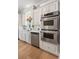 Modern kitchen features stainless steel double ovens, white cabinets, and marble countertops at 3508 Henrietta Hartford Rd, Mount Pleasant, SC 29466
