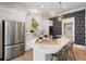 Bright kitchen features white cabinets, stainless steel appliances, and a large island with marble countertops at 3508 Henrietta Hartford Rd, Mount Pleasant, SC 29466