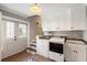 Well-lit laundry room with white cabinets, sink, and washer/dryer at 3508 Henrietta Hartford Rd, Mount Pleasant, SC 29466