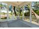 Cozy screened porch with panoramic views of the lush greenery and waterways beyond at 3508 Henrietta Hartford Rd, Mount Pleasant, SC 29466