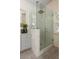Glass enclosed shower with a rainfall shower head, stone walls and gray vanity at 3508 Henrietta Hartford Rd, Mount Pleasant, SC 29466