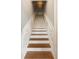 Elegant staircase featuring wood treads and white risers complemented by a classic white railing at 3508 Henrietta Hartford Rd, Mount Pleasant, SC 29466