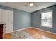 Bedroom featuring blue walls, hardwood floors, a ceiling fan, and a window at 359 Muirfield Pkwy, Charleston, SC 29414