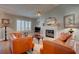 Cozy living room with a fireplace, bright window, ceiling fan, and hardwood floors at 359 Muirfield Pkwy, Charleston, SC 29414