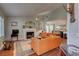 Open living room with a fireplace, hardwood floors, and a view of the dining room at 359 Muirfield Pkwy, Charleston, SC 29414