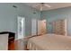 Relaxing main bedroom featuring blue walls, a ceiling fan, and private ensuite at 359 Muirfield Pkwy, Charleston, SC 29414