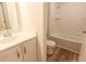 Bright bathroom featuring a shower-tub combo and wood-look flooring at 413 Mistflower Ln, Moncks Corner, SC 29461