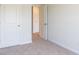Carpeted bedroom with a walk-in closet and an open doorway at 413 Mistflower Ln, Moncks Corner, SC 29461