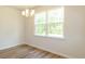 Dining area with a modern chandelier and a large window overlooking a lush, green landscape at 413 Mistflower Ln, Moncks Corner, SC 29461