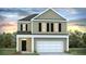Charming two-story home with a white garage door, complemented by a well-maintained lawn and appealing curb appeal at 413 Mistflower Ln, Moncks Corner, SC 29461