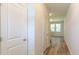 Hallway with wood-look flooring that leads to stairs and a living area with lots of natural light at 413 Mistflower Ln, Moncks Corner, SC 29461