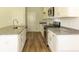 Bright kitchen with white cabinets, granite countertops, stainless steel appliances, and wood flooring at 413 Mistflower Ln, Moncks Corner, SC 29461