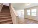 Open-concept space with staircase, living room area, and wood-look flooring at 413 Mistflower Ln, Moncks Corner, SC 29461