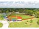 Aerial view of a well-maintained baseball field with green grass, red clay, and covered dugouts at 4631 Scout Aly, North Charleston, SC 29405