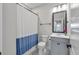 This bright bathroom features a blue and white shower curtain, and decorative tile floors at 4631 Scout Aly, North Charleston, SC 29405