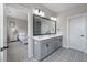 Bathroom features dual sinks, large mirror, neutral paint, and a view into the primary bedroom at 4631 Scout Aly, North Charleston, SC 29405