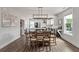 Bright dining area with wood floors, a modern chandelier and open access to the kitchen at 4631 Scout Aly, North Charleston, SC 29405