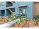 Exterior view of building entrance featuring blue facade, ramp access, and verdant landscaping at 4631 Scout Aly, North Charleston, SC 29405