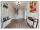 Bright entryway featuring hardwood floors, decorative console table, and a staircase leading to the upper level at 4631 Scout Aly, North Charleston, SC 29405