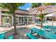 View of Paradiso's exterior, showing the market and turquoise picnic tables, shaded by a white umbrellas at 4631 Scout Aly, North Charleston, SC 29405