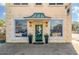 Alchemy Antique Jewelers with a decorative entrance, green door, and lush potted plants at 4631 Scout Aly, North Charleston, SC 29405