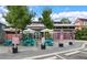 View of the Paradiso exterior showcasing turquoise picnic tables, umbrellas, and a patterned pink and white facade at 4631 Scout Aly, North Charleston, SC 29405
