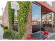 EVO Pizza, wood-fired pizzeria exterior with lush ivy, a large window, and cozy outdoor seating at 4631 Scout Aly, North Charleston, SC 29405