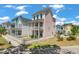 Side view of a charming two-story pink home with a white picket fence, set in a friendly neighborhood at 4631 Scout Aly, North Charleston, SC 29405