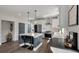This open-concept kitchen features an island with seating, stainless steel appliances, and modern pendant lighting at 4631 Scout Aly, North Charleston, SC 29405