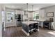 Bright modern kitchen with white cabinets, stainless steel appliances, and a gray island with bar stool seating at 4631 Scout Aly, North Charleston, SC 29405