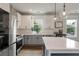 Bright kitchen features stainless steel appliances, quartz counters, white cabinets, and stylish pendant lighting at 4631 Scout Aly, North Charleston, SC 29405