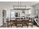Modern kitchen with an island, seating, stainless appliances, and stylish pendant lighting at 4631 Scout Aly, North Charleston, SC 29405
