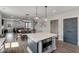 Open-concept kitchen features quartz island, stainless microwave, and is open to the dining and living area at 4631 Scout Aly, North Charleston, SC 29405
