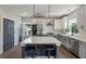 The kitchen features an island with seating, stainless steel appliances, subway tile backsplash and pendant lighting at 4631 Scout Aly, North Charleston, SC 29405