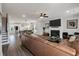 Open floor plan showcases living room fireplace and TV, visible from kitchen island and dining area at 4631 Scout Aly, North Charleston, SC 29405