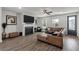 Bright living room features a fireplace, large TV, ceiling fan and a comfortable brown leather sectional sofa at 4631 Scout Aly, North Charleston, SC 29405