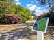 A disc golf course map sign features a lush field with pink azalea bushes and soaring pine trees at 4631 Scout Aly, North Charleston, SC 29405