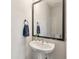 This powder room features a pedestal sink, large framed mirror, and stylish fixtures at 4631 Scout Aly, North Charleston, SC 29405