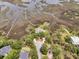 Beautiful waterfront home featuring multiple docks, a circular drive, and mature trees at 4702 Blockhouse Ln, Hollywood, SC 29449