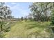 The backyard of this home features lush green grass and tropical trees with a marsh view at 4702 Blockhouse Ln, Hollywood, SC 29449