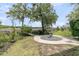 Backyard with landscaping, fountain, and lush trees overlooking the water and dock at 4702 Blockhouse Ln, Hollywood, SC 29449