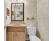 Quaint half bathroom with decorative wallpaper, vanity and mirror at 4702 Blockhouse Ln, Hollywood, SC 29449