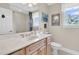 Bathroom vanity with a marble countertop, sink, large mirror, and view of the toilet at 4702 Blockhouse Ln, Hollywood, SC 29449
