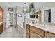 Bright bathroom featuring a marble-topped vanity, large mirror and a decorative light fixture at 4702 Blockhouse Ln, Hollywood, SC 29449