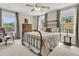 Cozy bedroom featuring a metal bed frame, soft carpet, and windows overlooking the outdoors at 4702 Blockhouse Ln, Hollywood, SC 29449