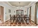 Formal dining room with elegant chandelier, decorative ceiling, and hardwood floors at 4702 Blockhouse Ln, Hollywood, SC 29449