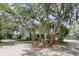 Charming home with mature trees and lush landscaping, featuring a grand porch with views of the surrounding landscape at 4702 Blockhouse Ln, Hollywood, SC 29449